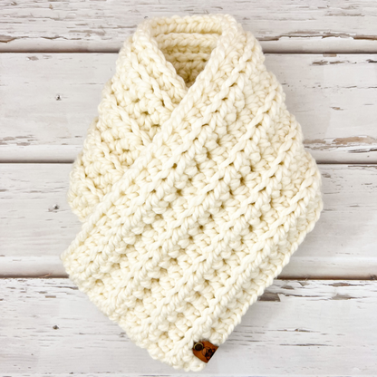 Our infinity scarf in the colour vanilla displayed on wooden slats